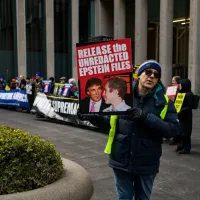 Trump and Epstein photos projected onto the hotel before correspondents' dinner